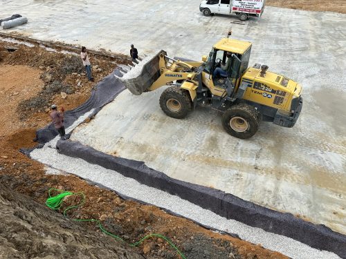 AFSÜ sahasında geotekstil serilmiş drenaj kanalına Komatsu lastikli yükleyicimiz ve saha ekibimizle agrega yerleştirdiğimiz altyapı çalışması.
